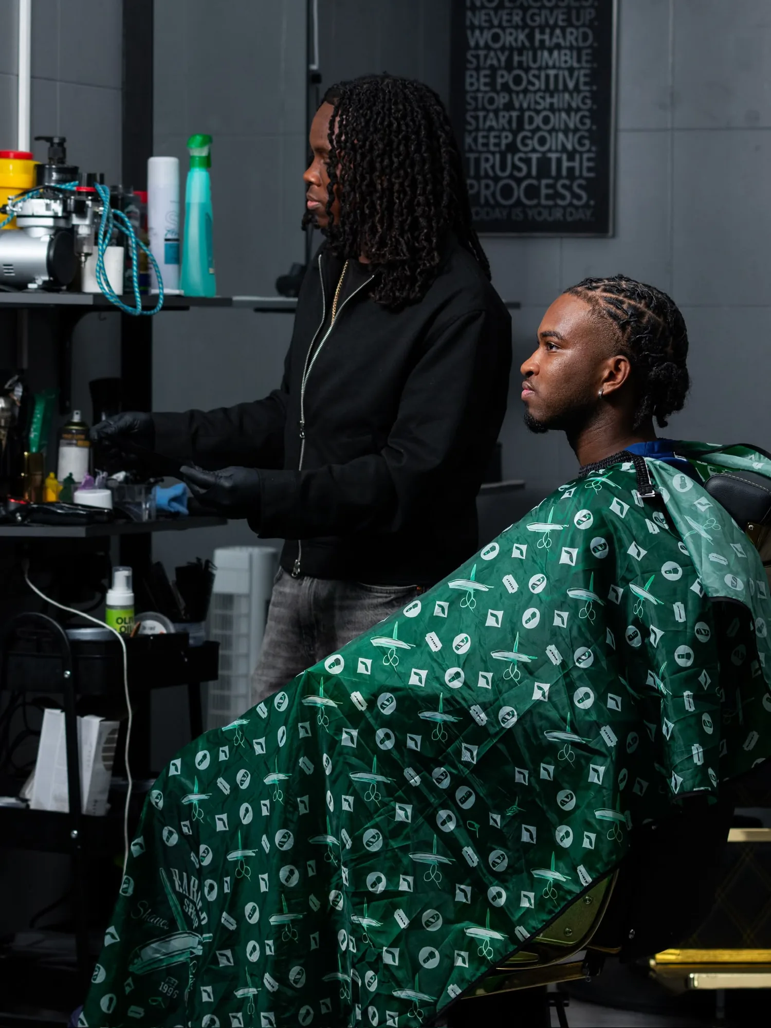 Cliente sentado com tranças e acabamento cuidado na Elly Barbershop